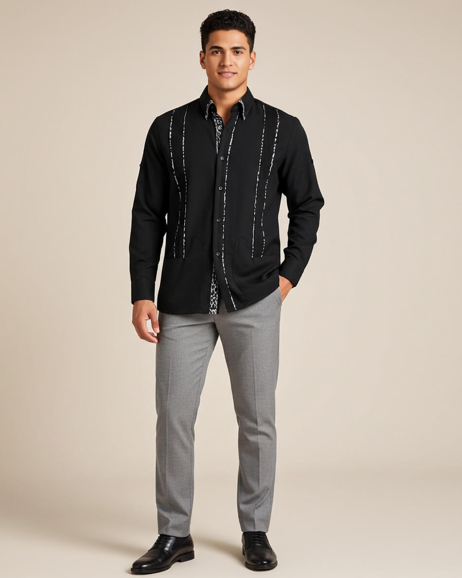 Man wearing a black leopard guayabera shirt with gray pants on a beige background