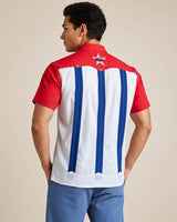 Man wearing a red, white, and blue striped shirt with a star emblem on the back.