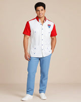 Man wearing a white shirt with red sleeves and blue pants on a beige background