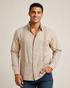 Man wearing a beige button-up guayabera shirt with a plain background