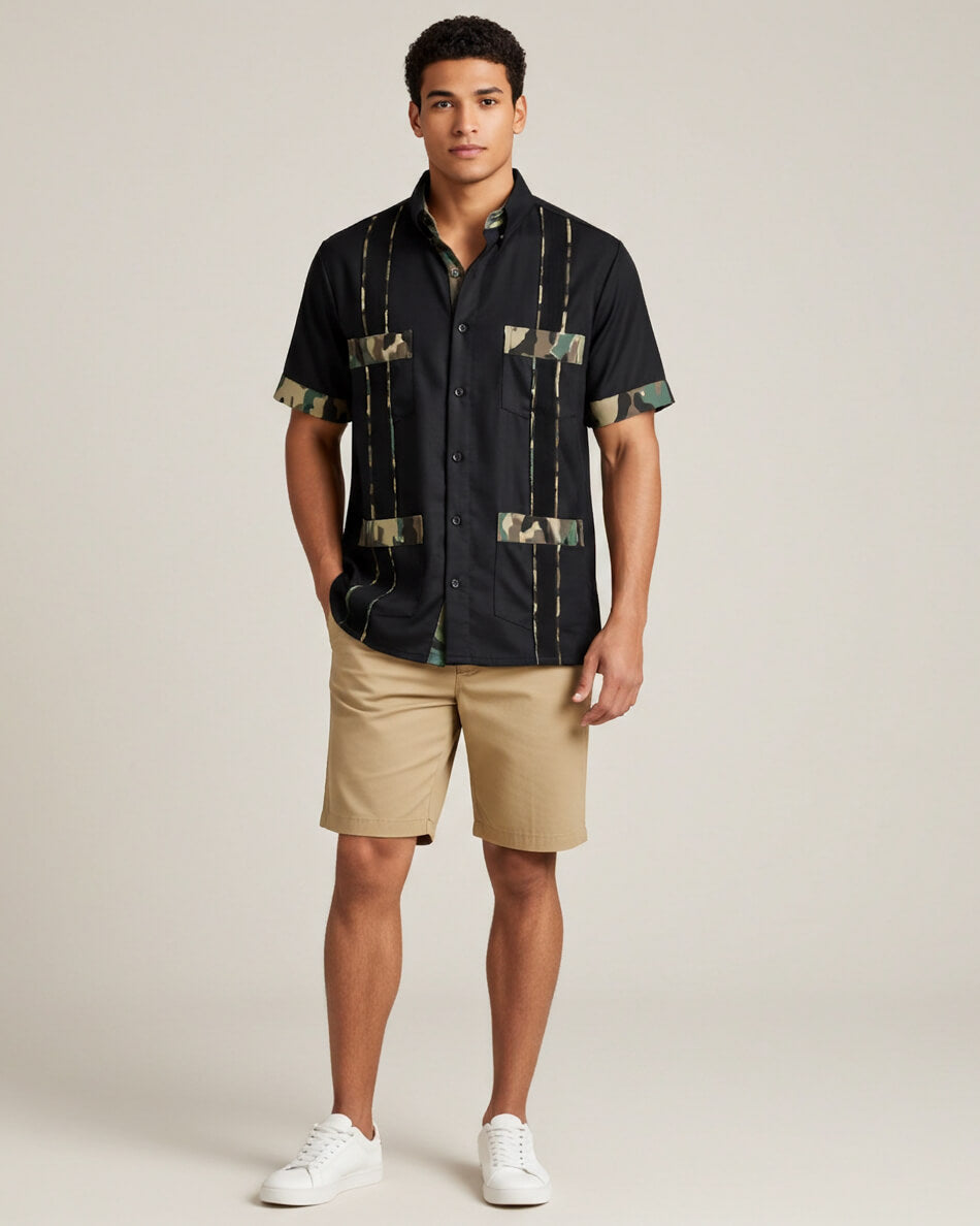Man wearing a black camo guayabera shirt and beige shorts on a plain background