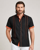 Man wearing a black shirt with copper accents on a plain background