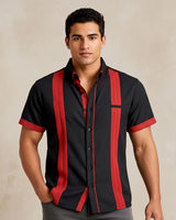 Man wearing a black presidencial guayabera shirt with red accents on a beige background