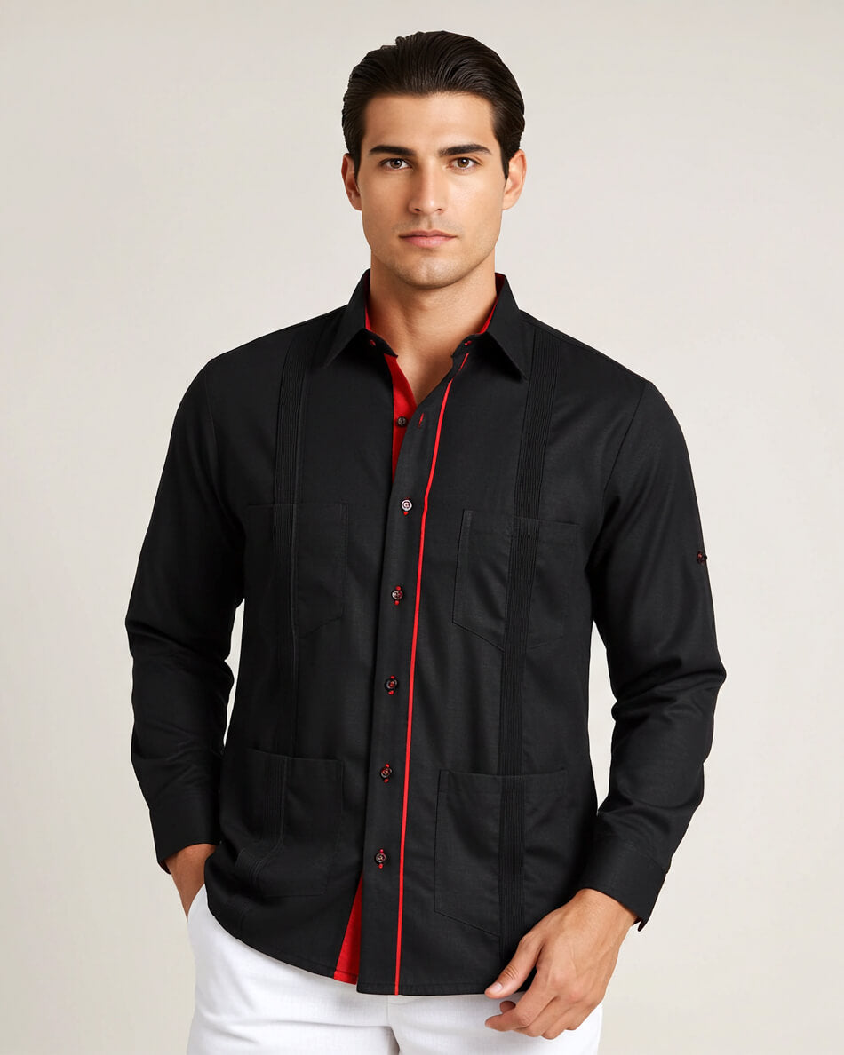 Man wearing a black guayabera shirt with red accents on a plain background
