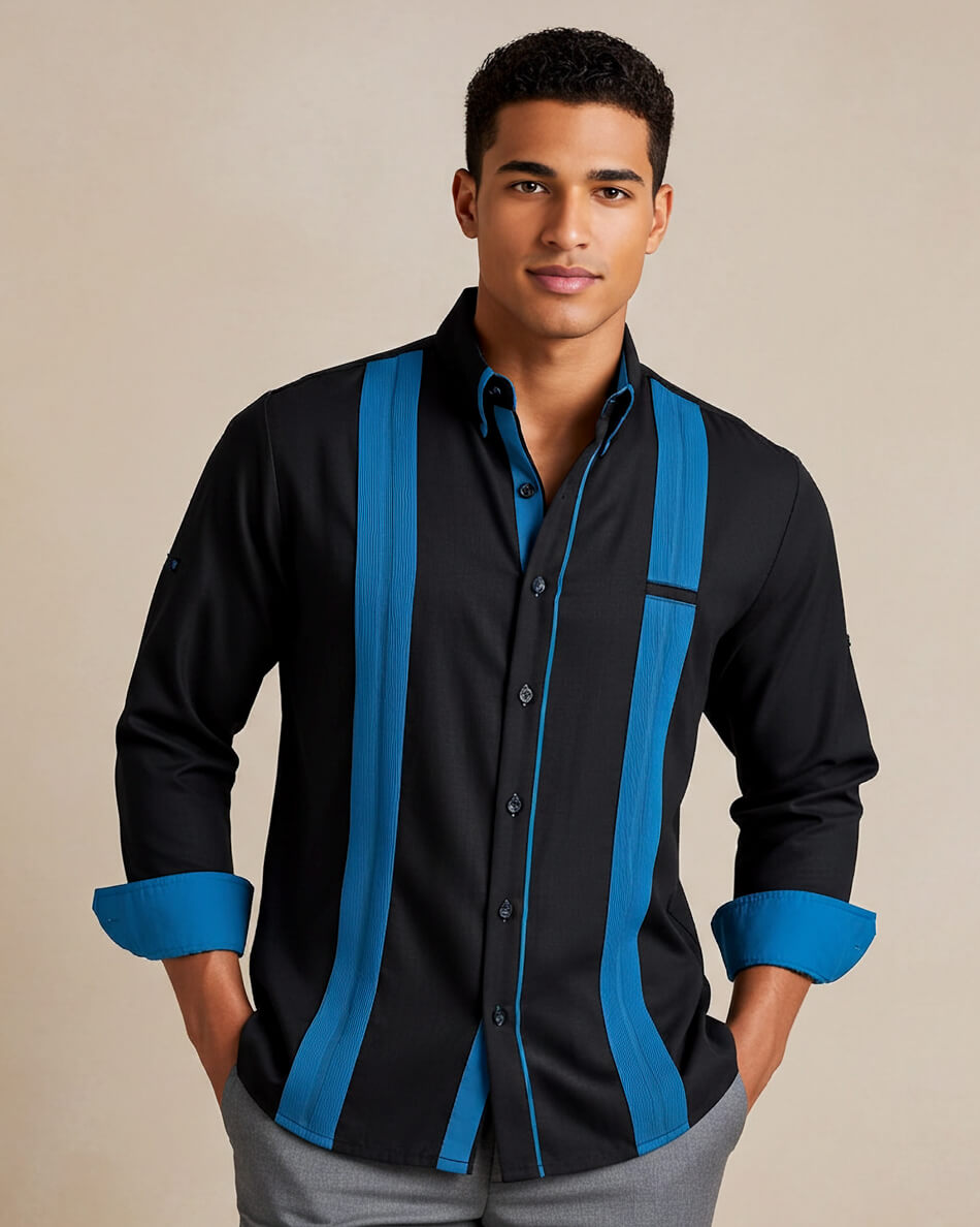 Man wearing a black guayabera shirt with blue accents on a beige background