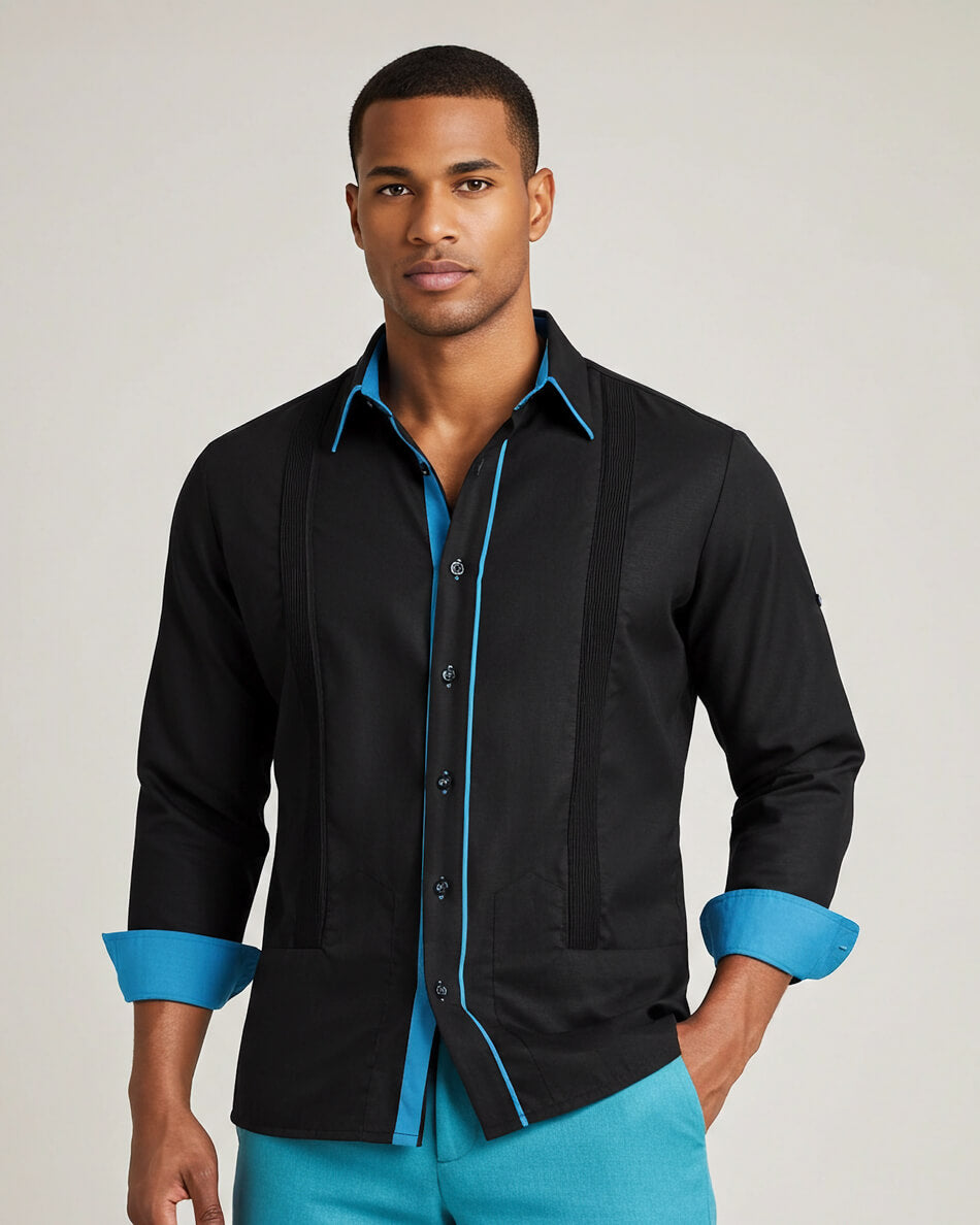 Man wearing a black guayabera shirt with blue accents on a plain background