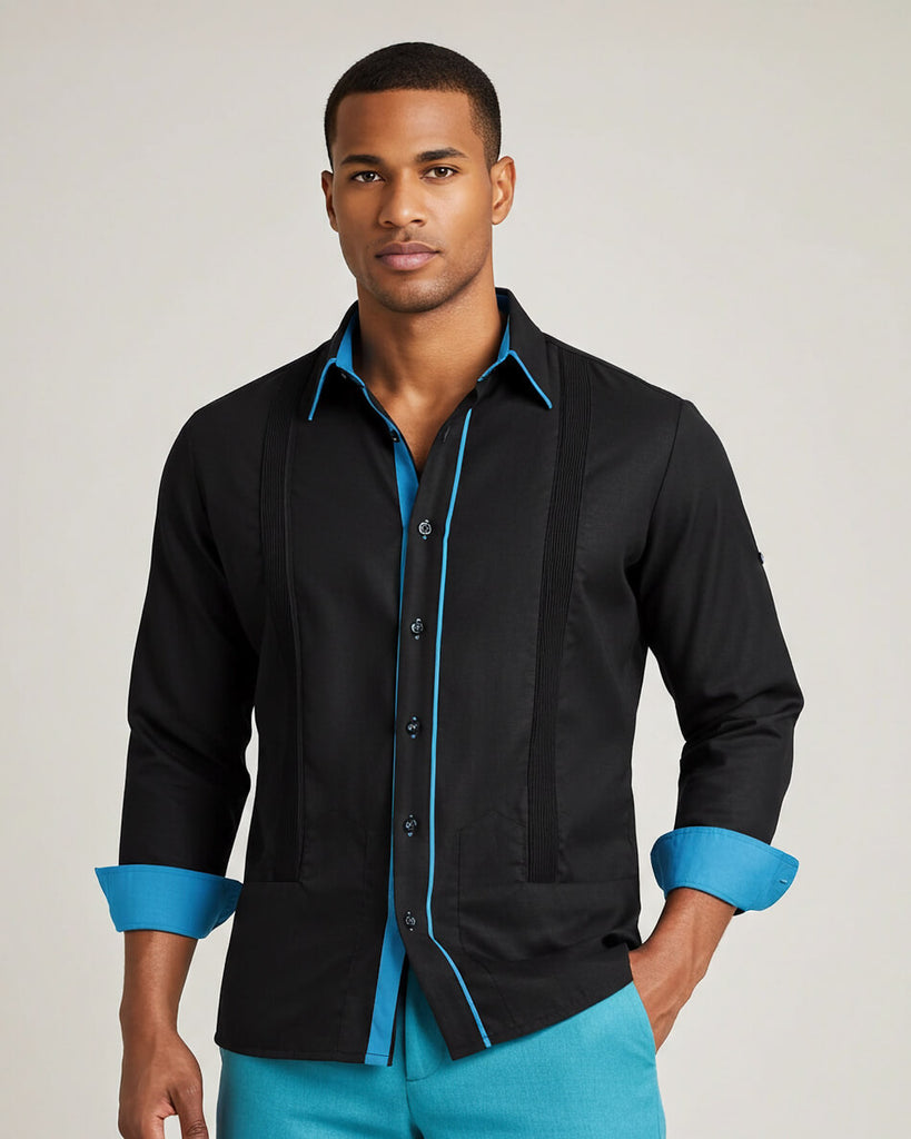 Man wearing a black guayabera shirt with blue accents on a plain background