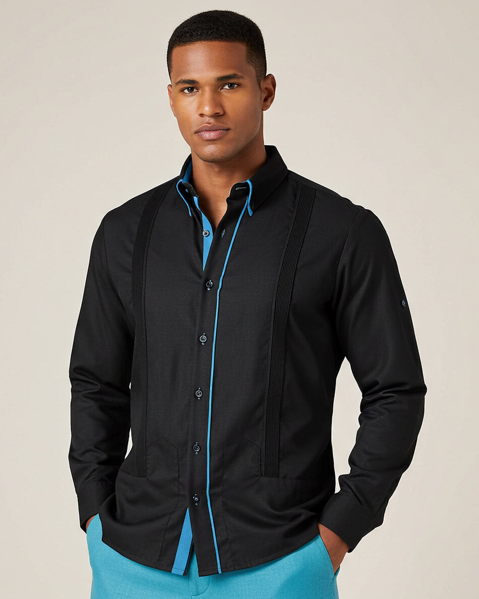 Man wearing a black long sleeve guayabera with blue accents on a beige background