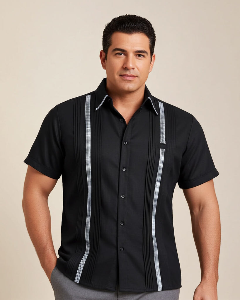 Man wearing a black shirt with houndstooth stripes and gray pants on a beige background