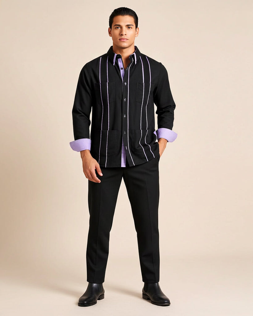 Man wearing a black guayabera shirt with purple gingham accents and cuffs on a beige background