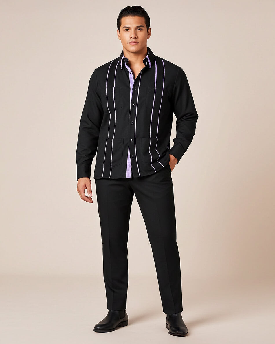 Man wearing a black guayabera shirt with purple gingham accents and cuffs on a beige background