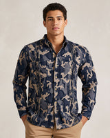 Man wearing a navy blue camouflage guayabera shirt against a plain background
