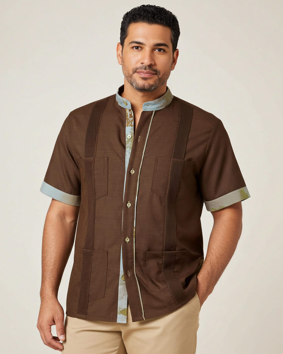 Man wearing a brown short-sleeve shirt with light blue accents on a beige background