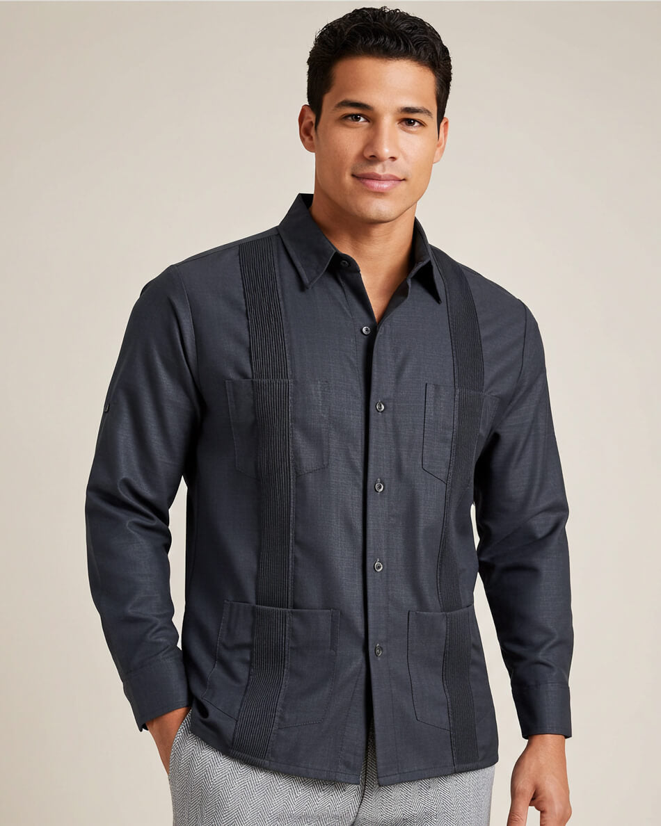 Man wearing a dark grey long-sleeve guayabera shirt on a beige background