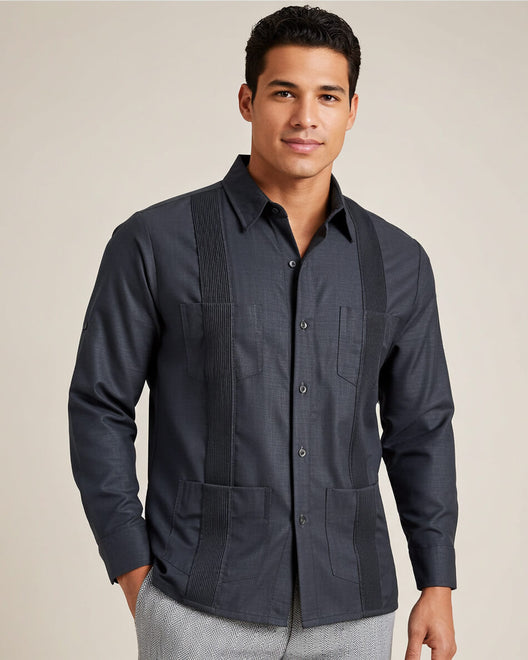 Man wearing a dark grey long-sleeve guayabera shirt on a beige background
