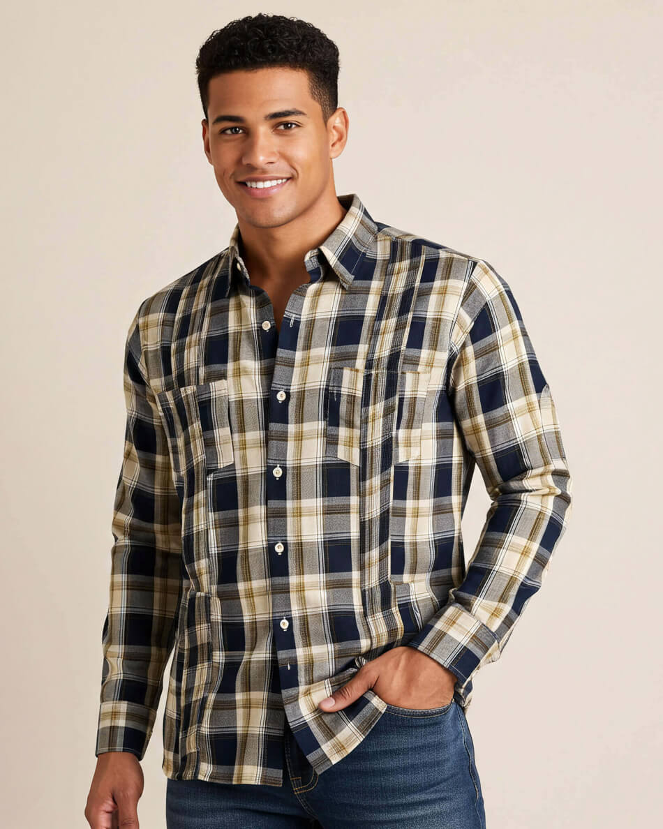 Man wearing a plaid shirt with a neutral background