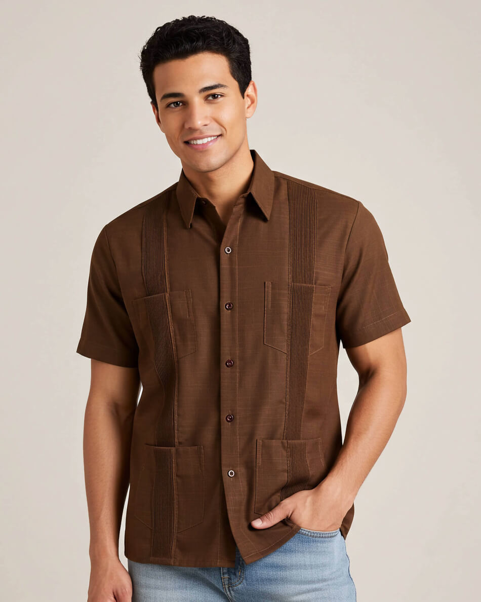Man wearing a brown short-sleeve guayabera shirt with a neutral background