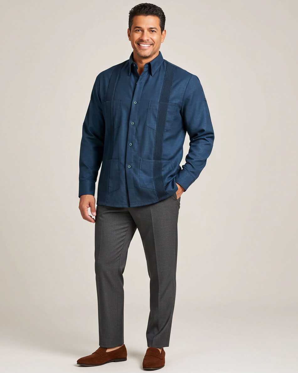 Man wearing a deep teal shirt and gray pants on a beige background