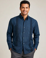 Man wearing a dark teal shirt against a plain background