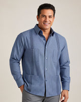 Man wearing a blue checkered guayabera shirt against a plain background