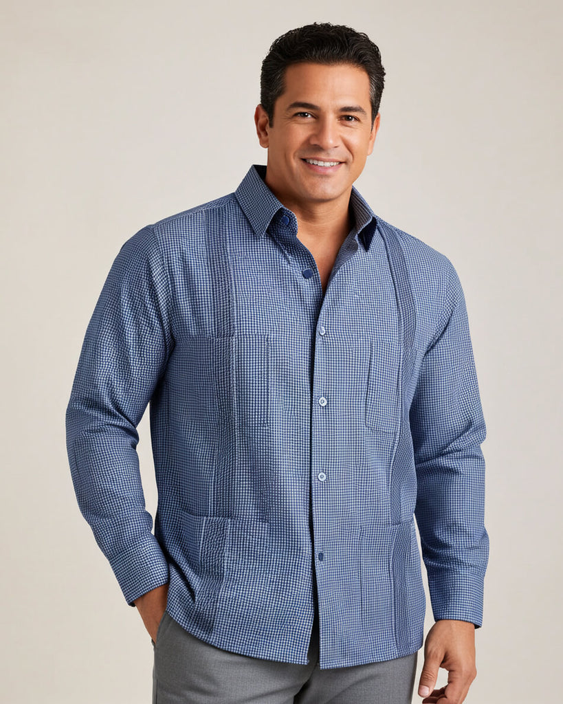 Man wearing a blue checkered guayabera shirt against a plain background