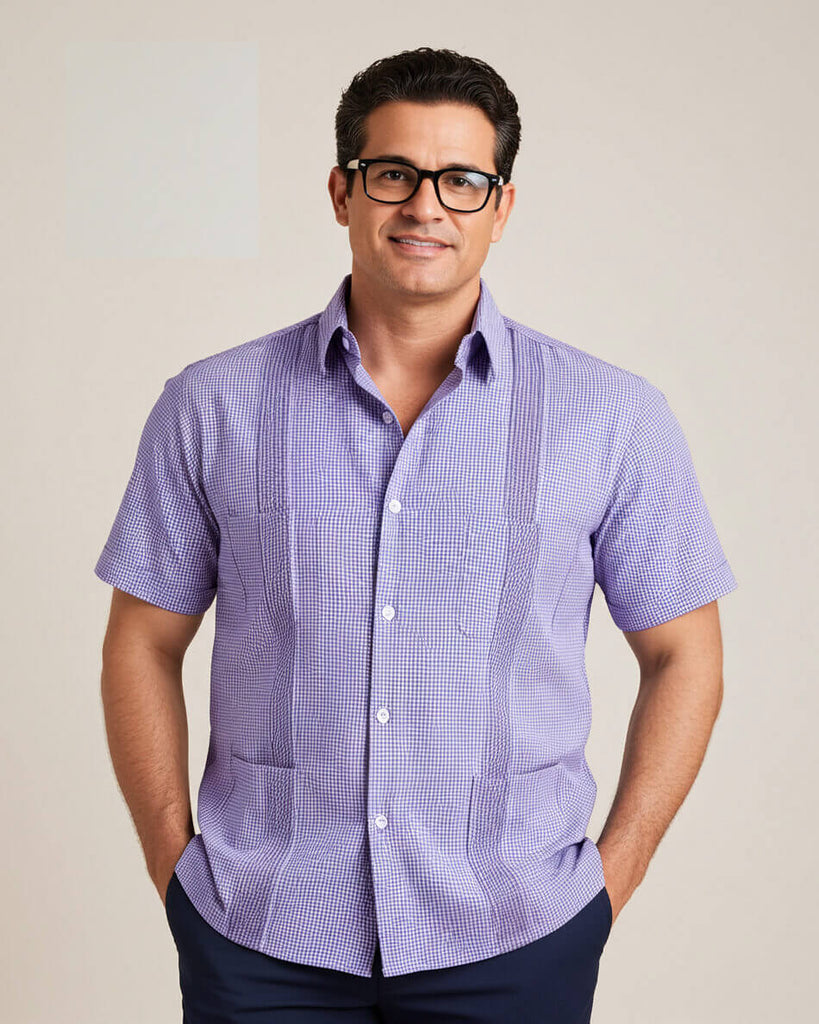 Man wearing a purple checkered guayabera shirt against a beige background