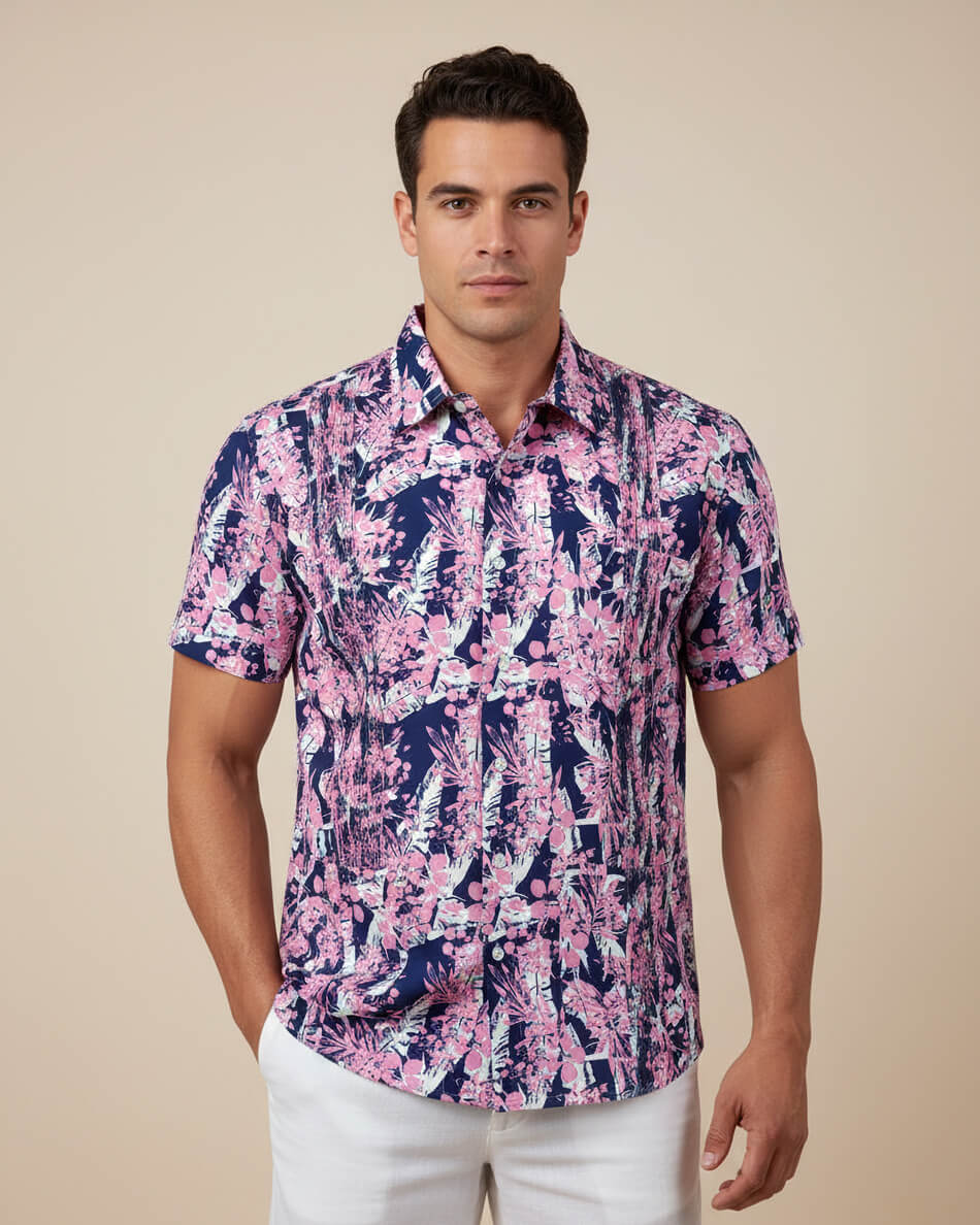 Man wearing a pink and blue floral patterned shirt against a beige background