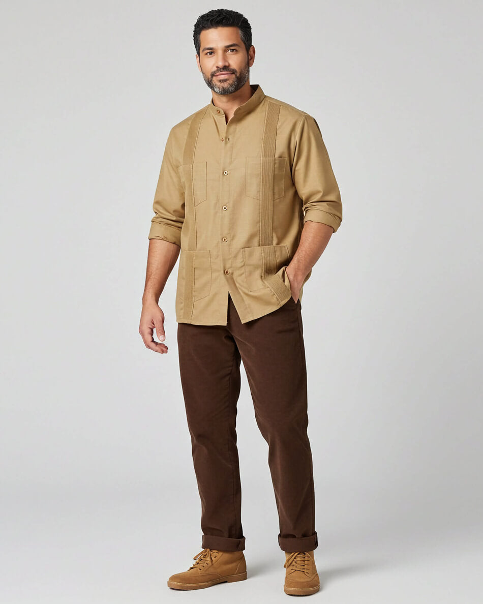 Man wearing a khaki guayabera shirt and brown pants on a white background