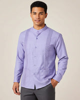 Man wearing a light purple Guayabera shirt against a beige background