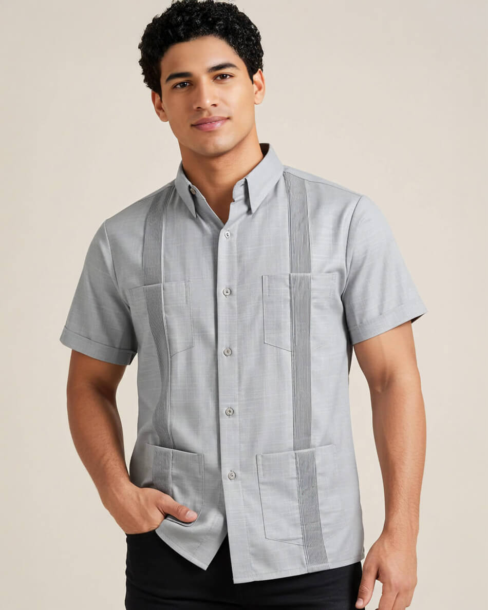 Man wearing a light gray short-sleeve guayabera shirt with pintuck pleats on a beige background