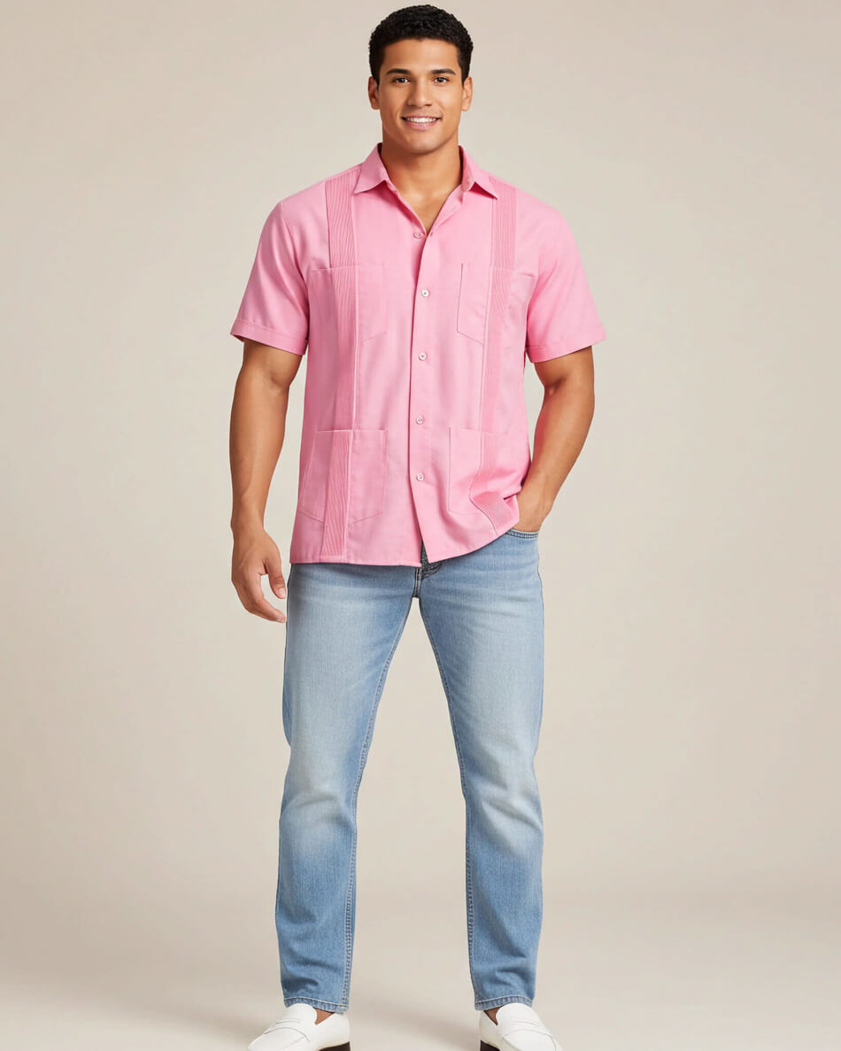 Man wearing a pink guayabera shirt and blue jeans on a beige background