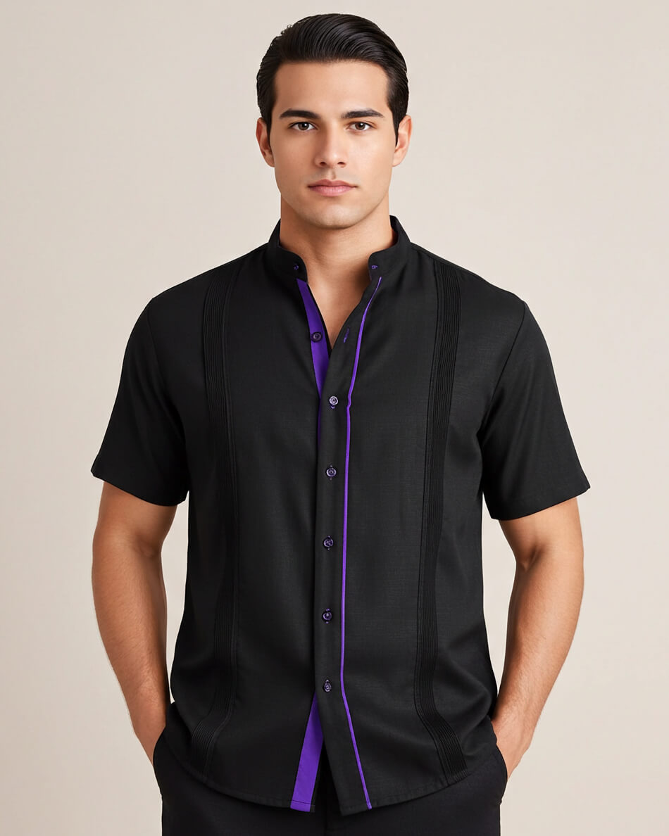 Man wearing a black guayabera shirt with purple accents on a beige background