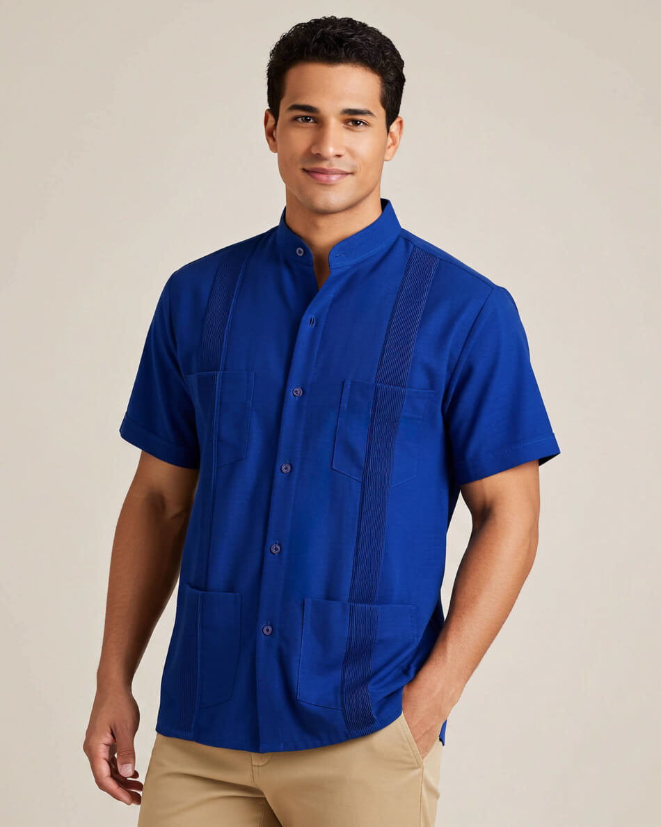 Man wearing a blue short-sleeve guayabera shirt with a banded collar on a beige background