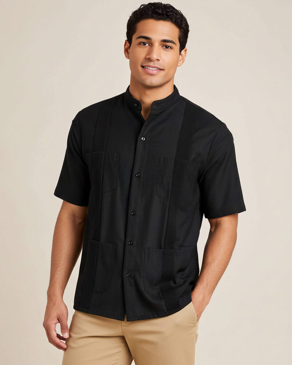 Man wearing a black short-sleeve guayabera shirt with buttons on a beige background