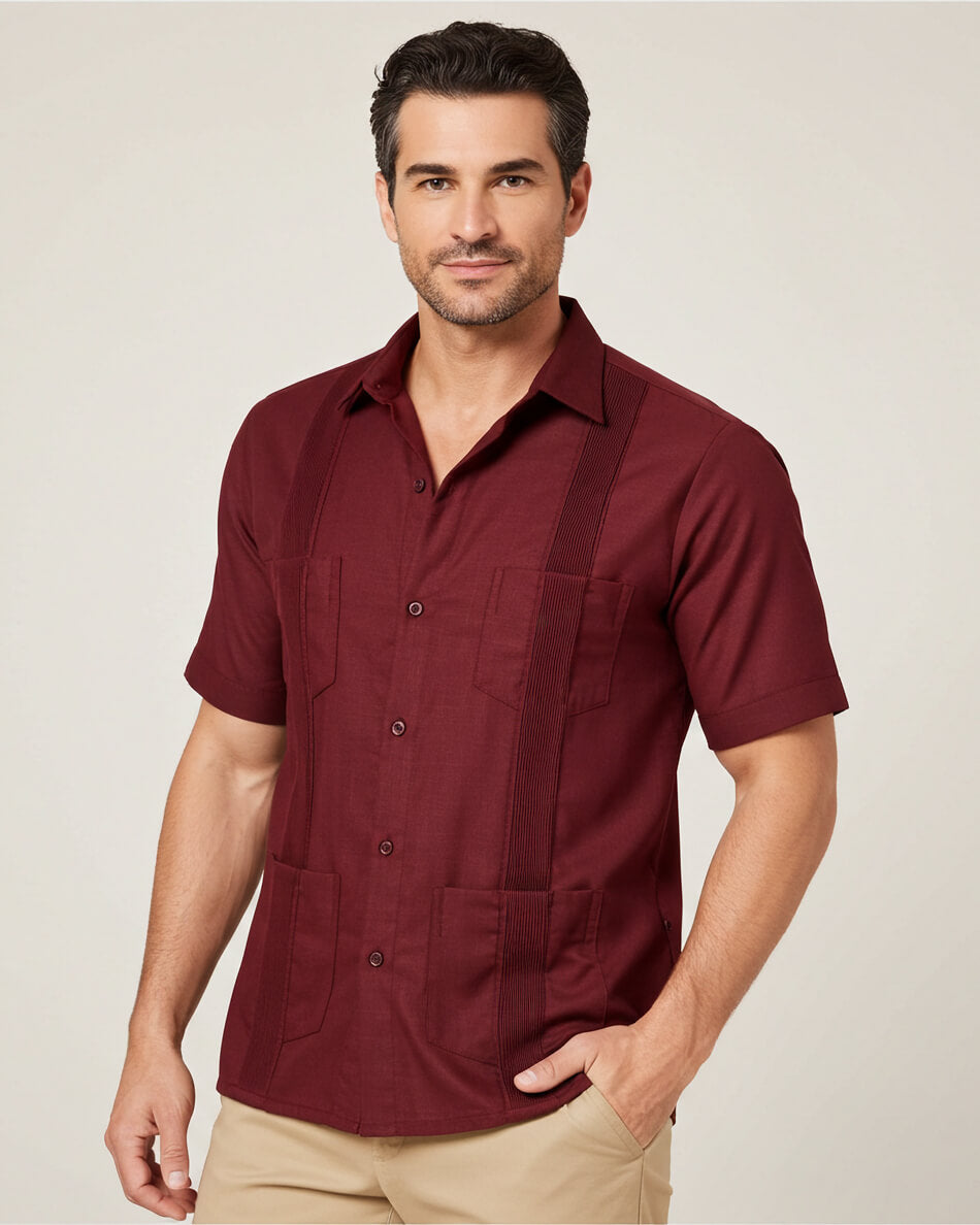 Man wearing a maroon guayabera short-sleeve shirt with pockets on a plain background