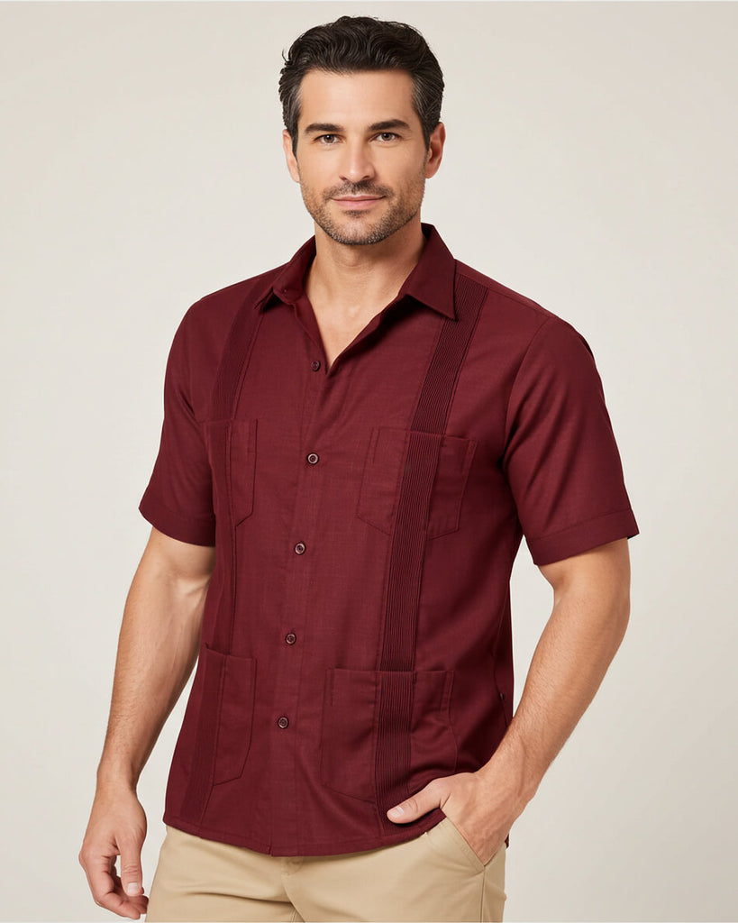 Man wearing a maroon guayabera short-sleeve shirt with pockets on a plain background