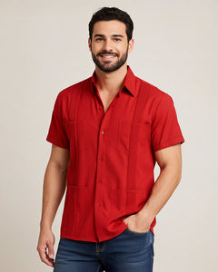 Man wearing a red guayabera short-sleeve shirt against a beige background