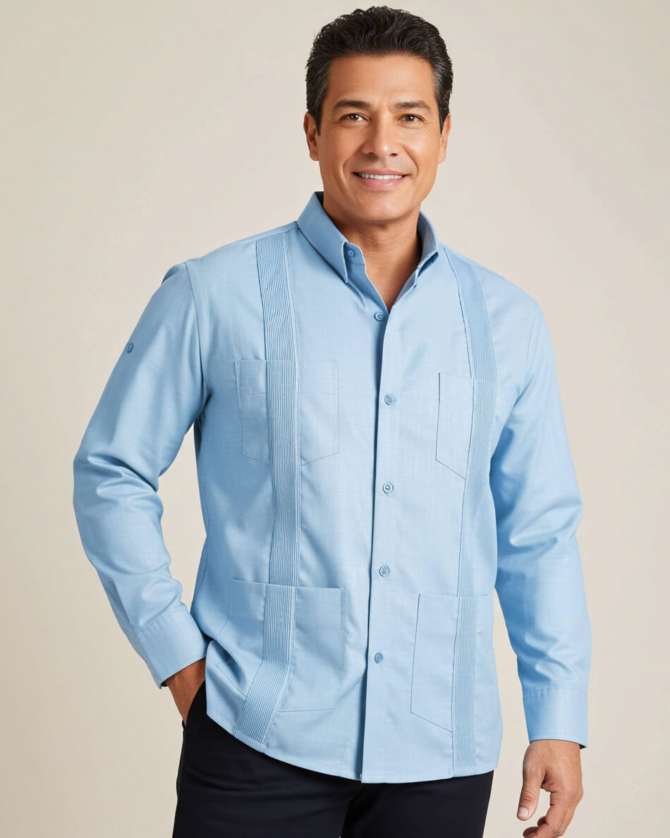 Man wearing a light blue guayabera shirt against a beige background