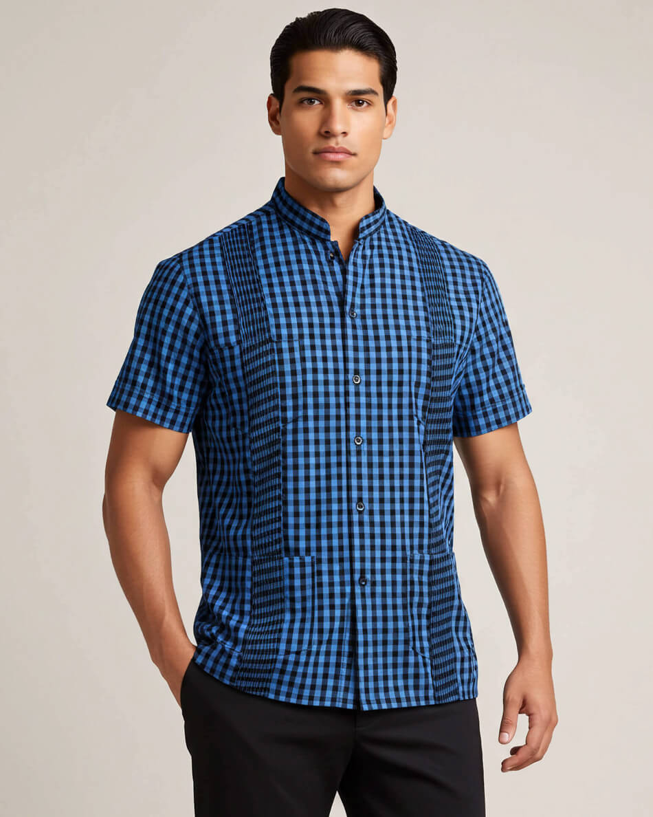 Man wearing a blue and black checkered shirt against a plain background