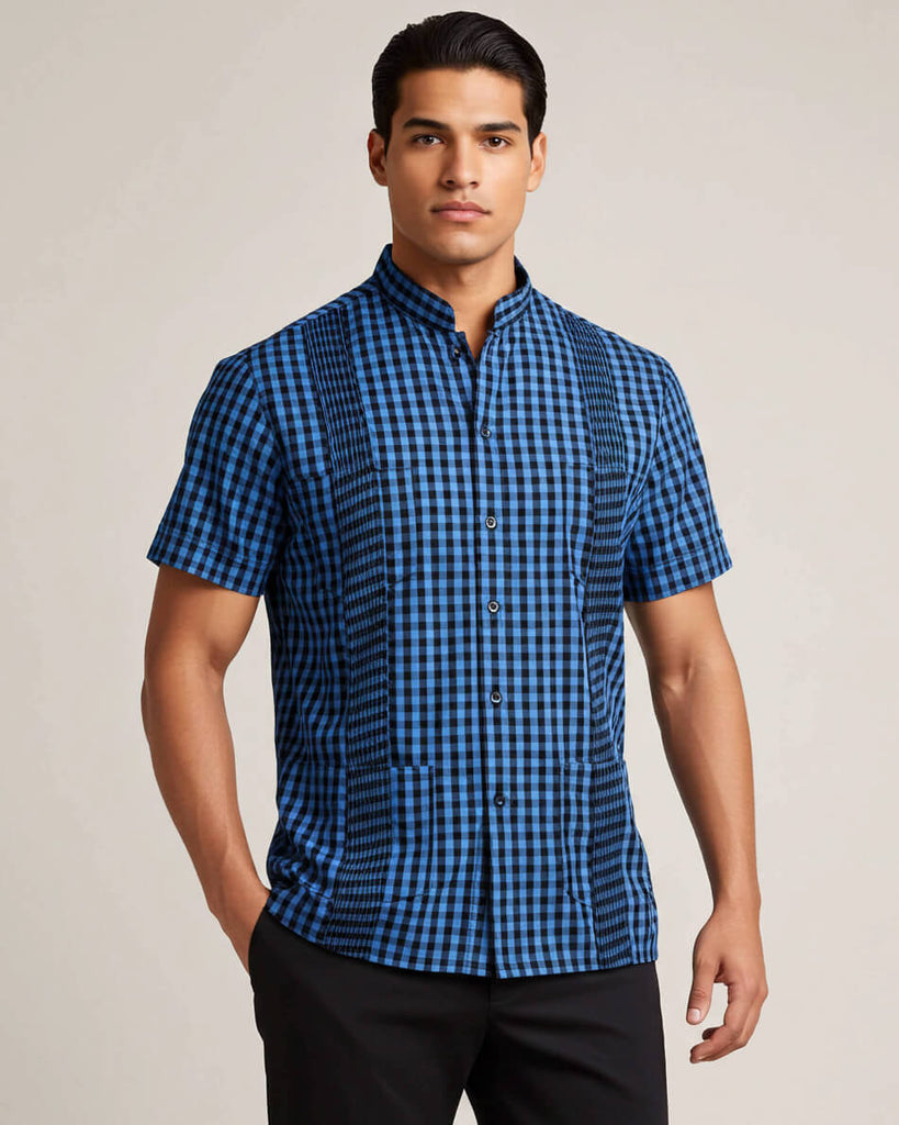 Man wearing a blue and black checkered shirt against a plain background