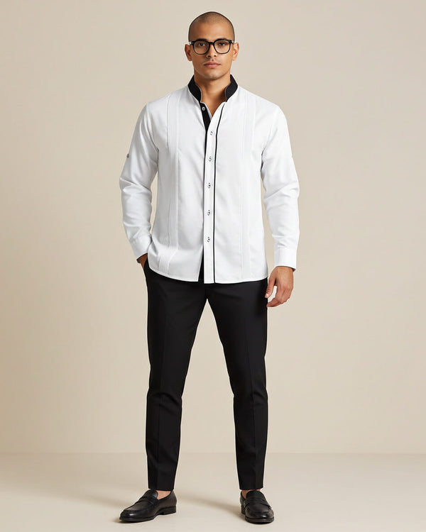 Man wearing a white guayabera shirt and black pants on a beige background