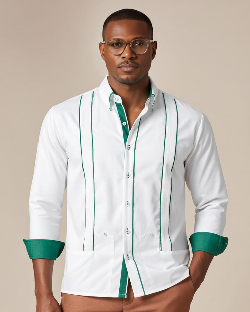 Man wearing a white guayabera shirt with green accents on a beige background