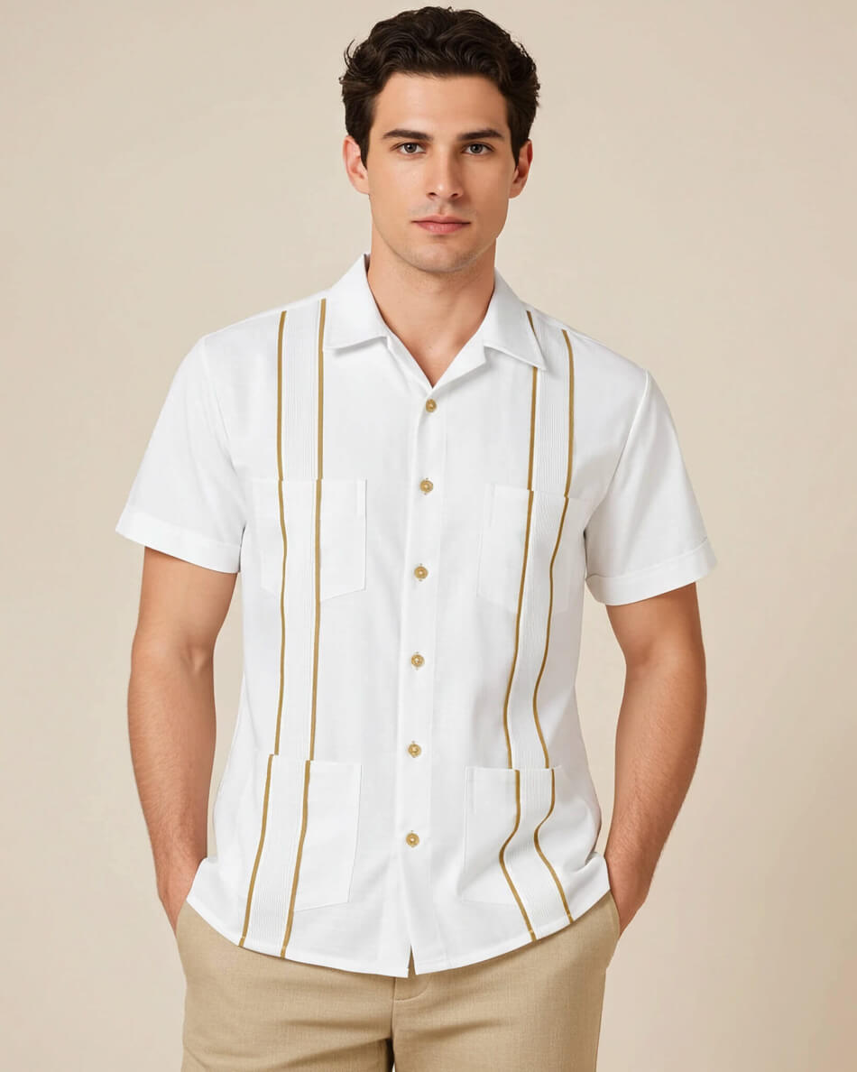 Man wearing a white guayabera shirt with khaki accents against a beige background