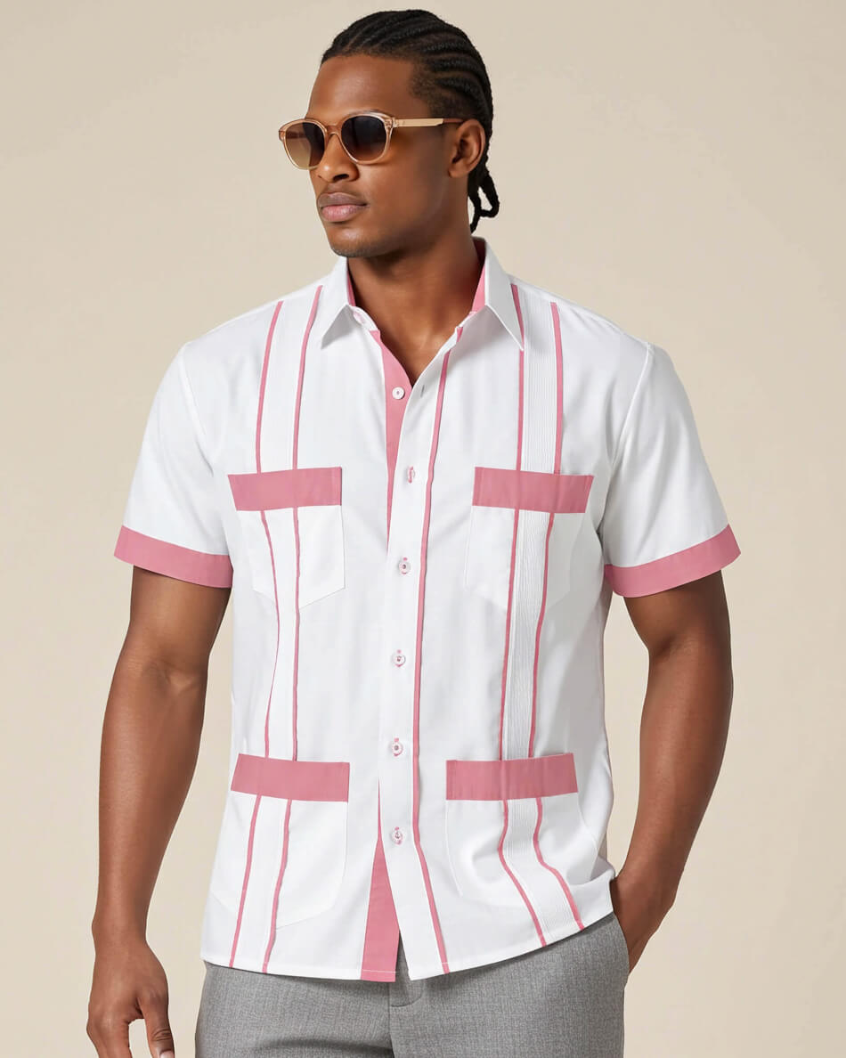 Man wearing a white guayabera shirt with pink accents and sunglasses on a beige background