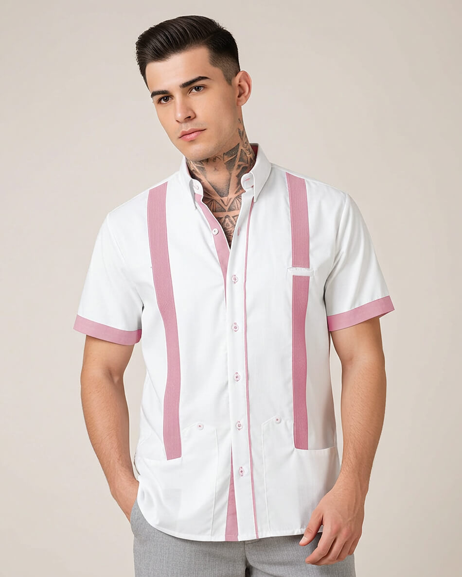 Man wearing a white guayabera shirt with pink accents on a beige background