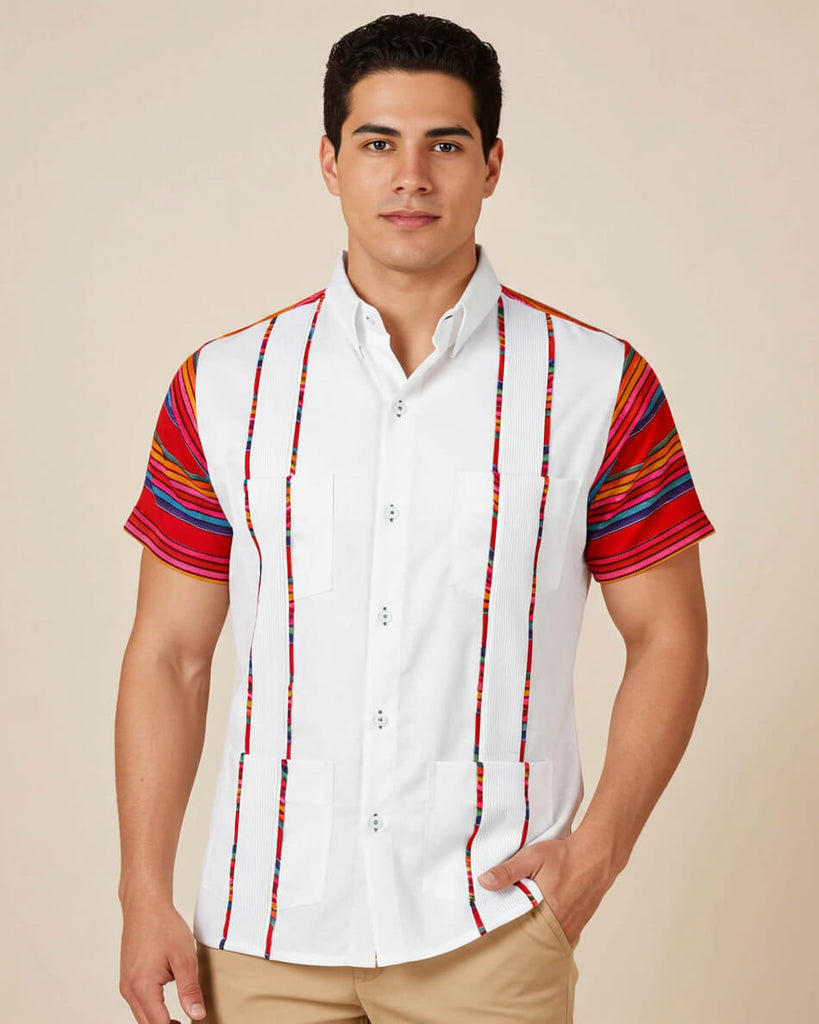 Man wearing a white guayabera shirt with colorful striped sleeves on a beige background