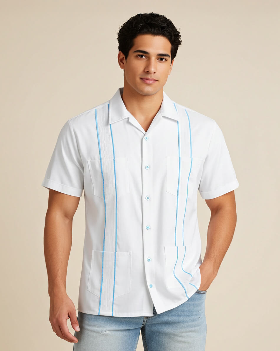 Man wearing a white guayabera short-sleeve shirt with sky blue accented pleats and light blue shorts on a beige background