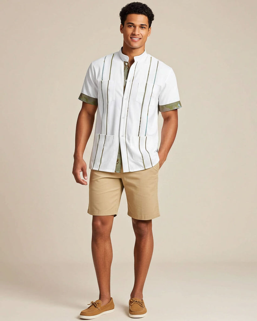 Man wearing a white guayabera shirt with green camo accents and beige shorts on a beige background
