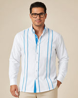 Man wearing a white guayabera shirt with turquoise stripes on a beige background