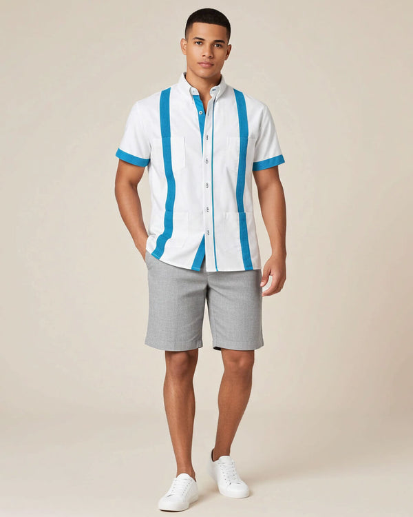 Man wearing a white guayabera shirt with turquoise stripes and gray shorts on a beige background